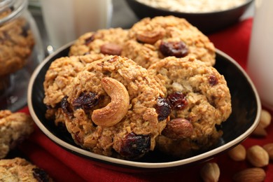 Photo of Delicious oatmeal cookies with raisins and nuts on table, closeup