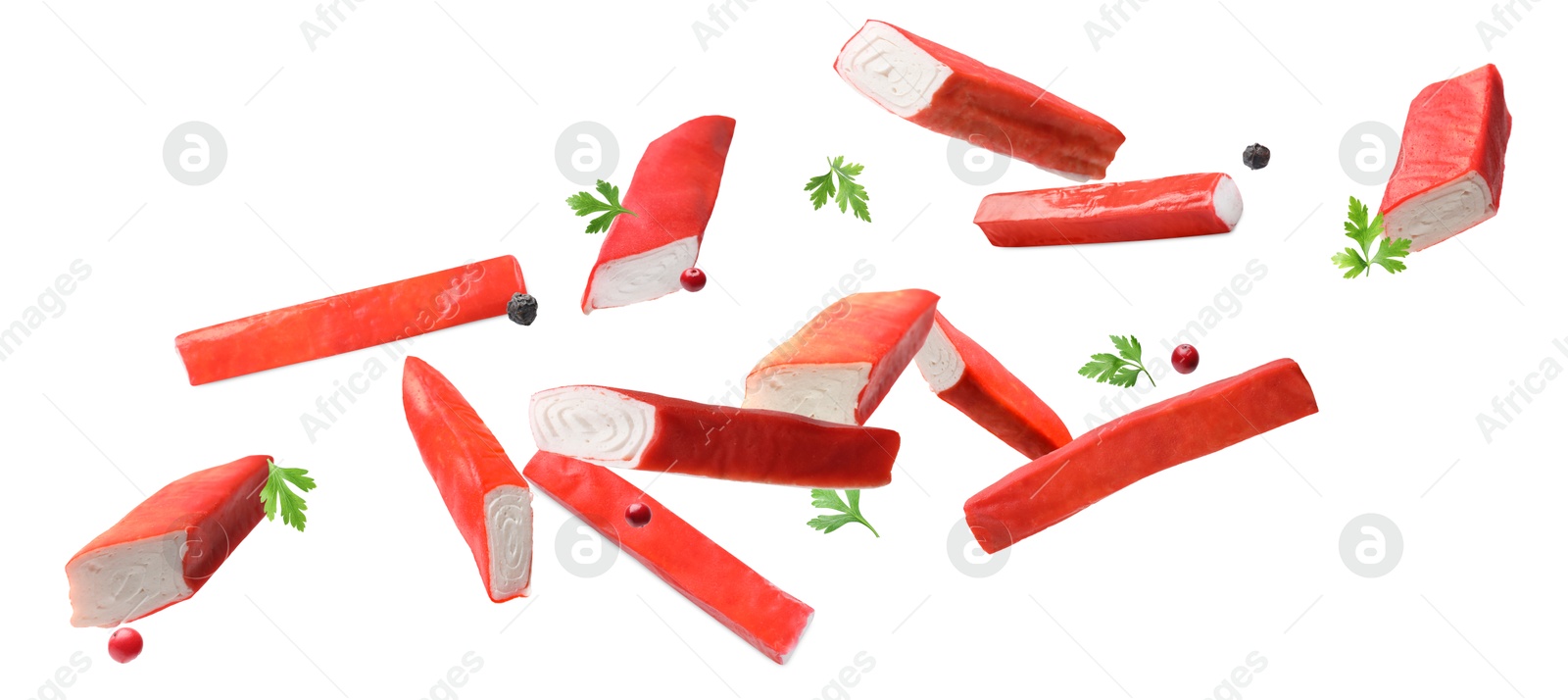 Image of Crab stick pieces, parsley and mix of peppers in air on white background