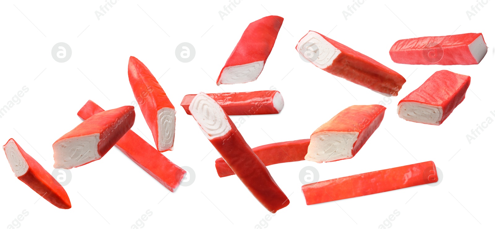 Image of Crab stick pieces in air on white background