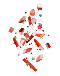 Crab stick pieces, parsley and mix of peppers in air on white background