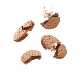 Image of Tasty broken sandwich cookies in air on white background