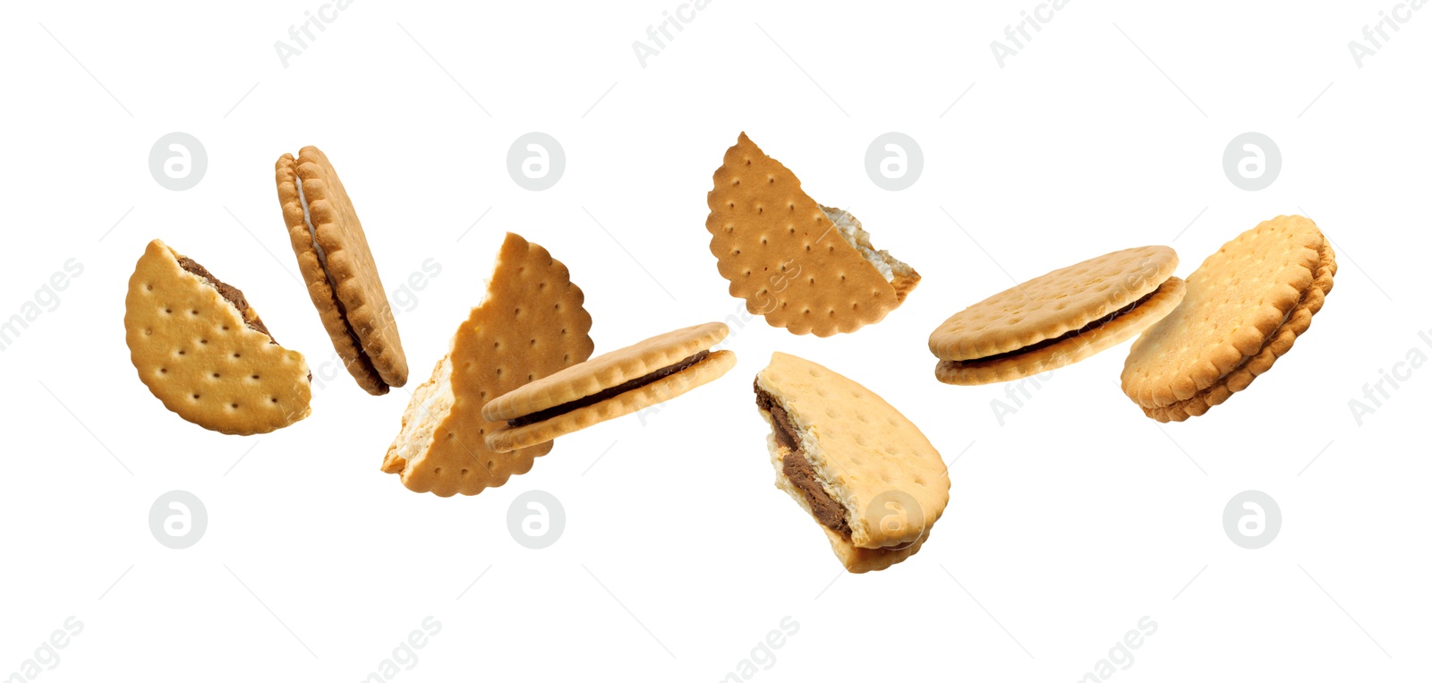 Image of Tasty broken sandwich cookies in air on white background