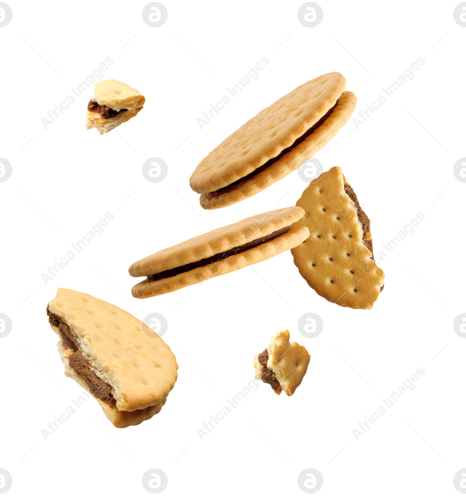 Image of Tasty broken sandwich cookies in air on white background