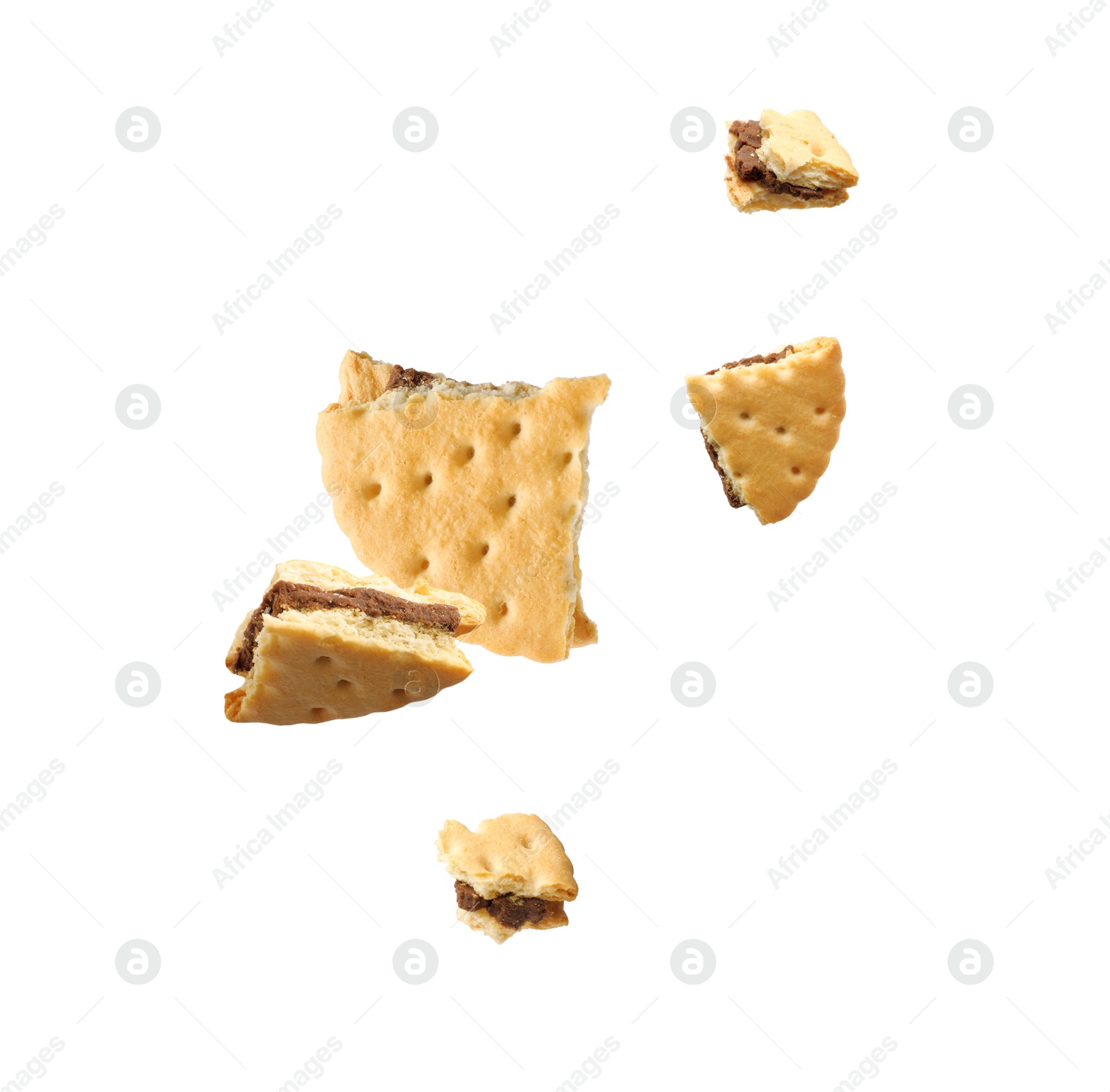 Image of Tasty broken sandwich cookie in air on white background