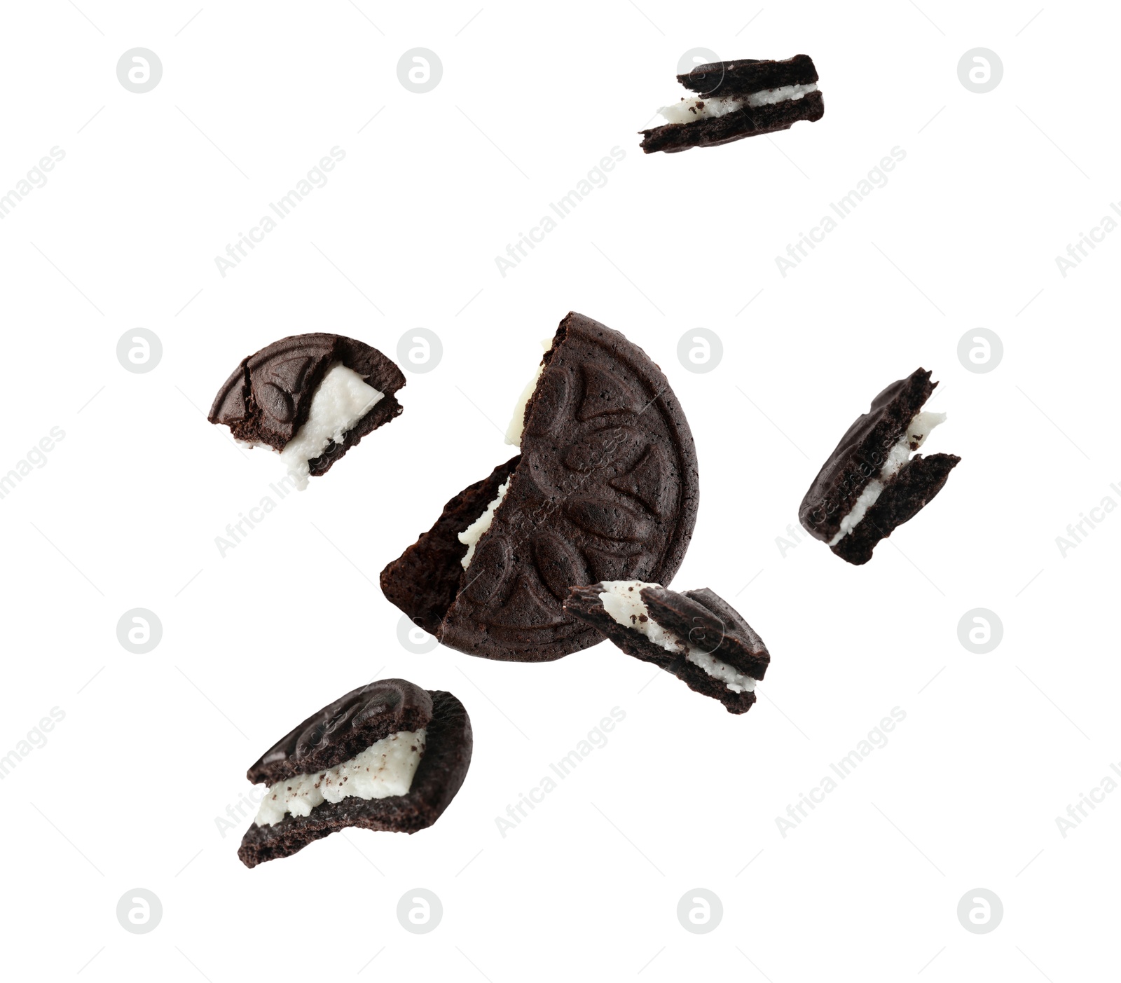 Image of Tasty broken sandwich cookie in air on white background