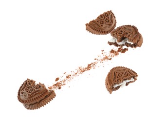 Image of Tasty broken sandwich cookies in air on white background