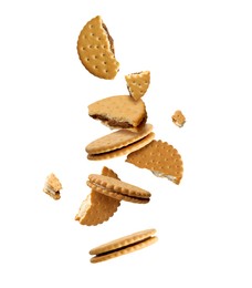 Image of Tasty broken sandwich cookies in air on white background