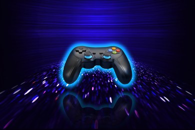 Image of Glowing video game controller on dark blue gradient background with speed light trails, motion blur effect. Creative poster