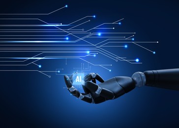 Image of AI abbreviation in robot hand on dark blue background with electric circuit board pattern