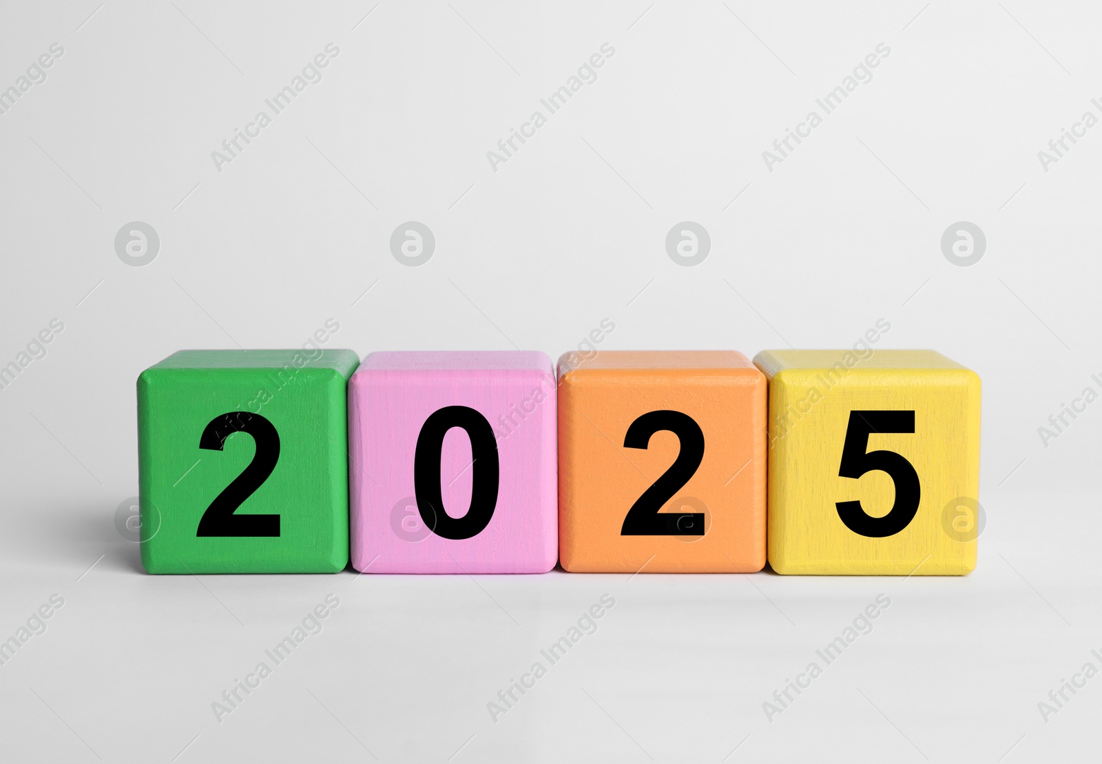 Image of 2025 New Year, colorful wooden cubes with numbers on white table, closeup