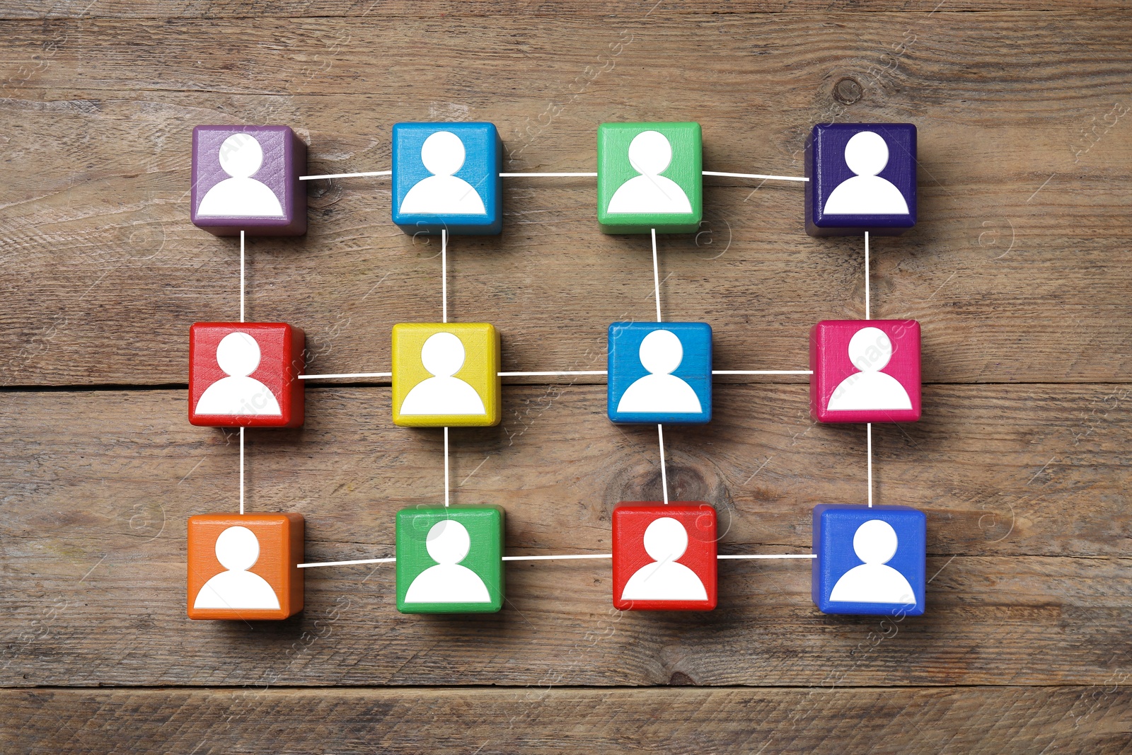 Image of Human resource. Scheme of colorful cubes with human icons on wooden background, top view