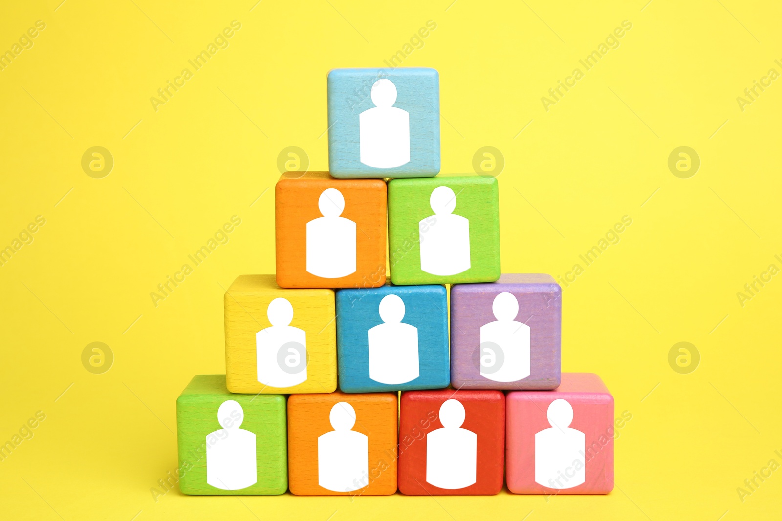 Image of Human resource. Pyramid of colorful cubes with human icons on yellow background