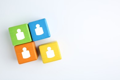 Image of Human resource. Colorful cubes with human icons on white background, top view