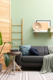 Photo of Living room with stool and sofa. Stylish interior design