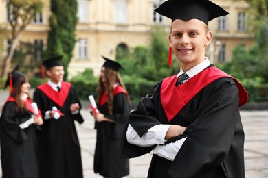 Photo of Graduation ceremony. Happy students outdoors, selective focus