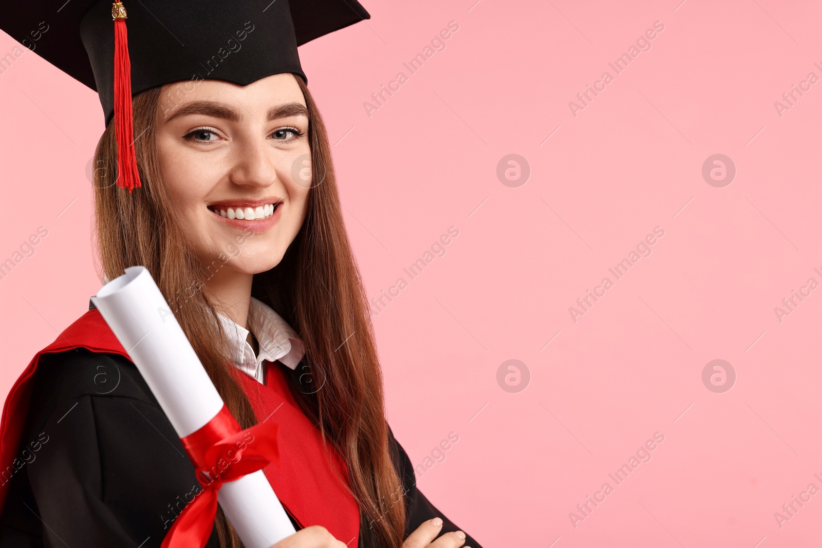 Photo of Happy student with diploma after graduation on pink background. Space for text