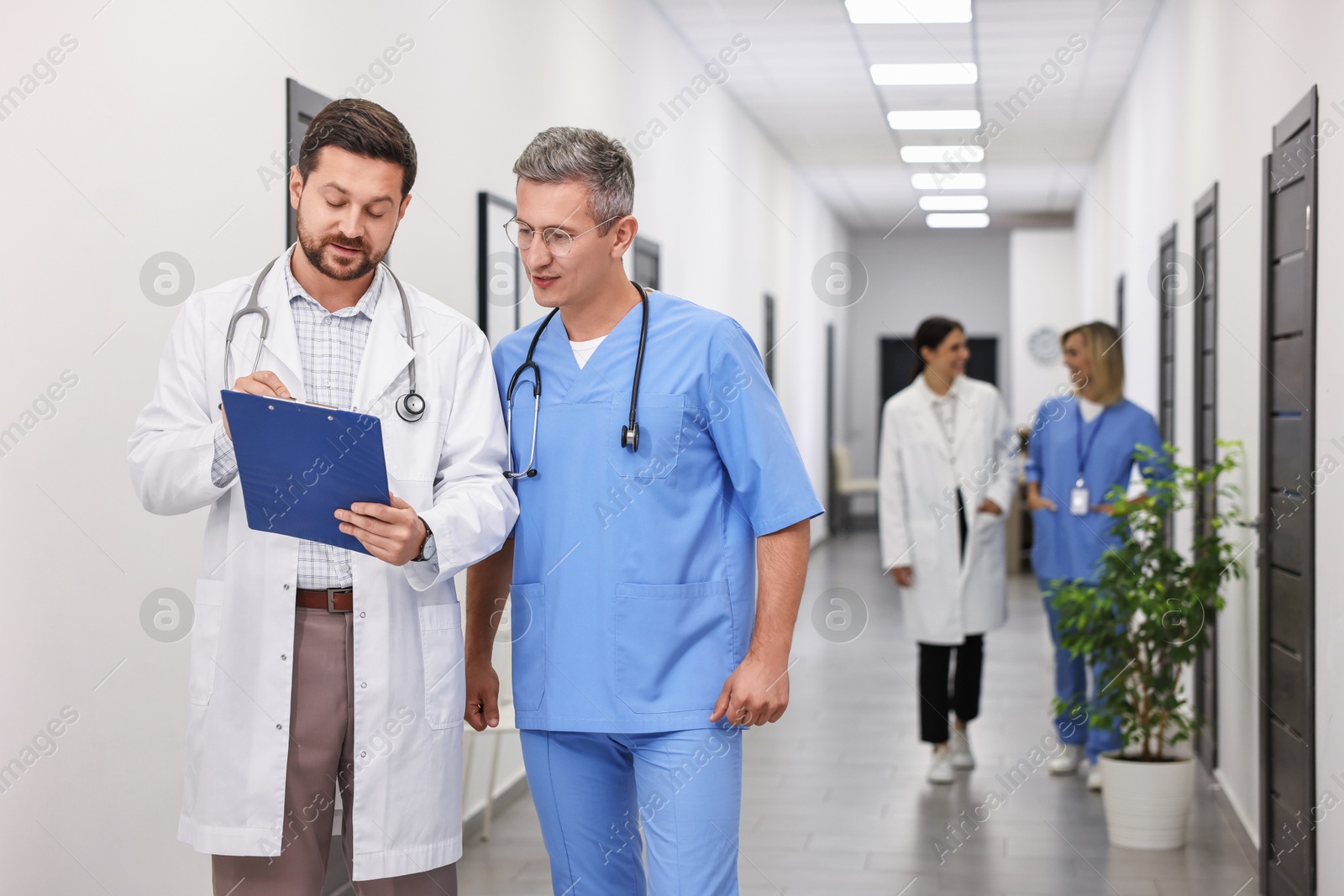 Photo of Healthcare workers with clipboard in hospital. Medical service