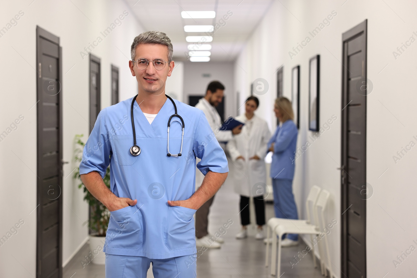 Photo of Healthcare workers in hospital, selective focus. Portrait of smiling nurse indoors