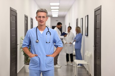 Healthcare workers in hospital, selective focus. Portrait of smiling nurse indoors