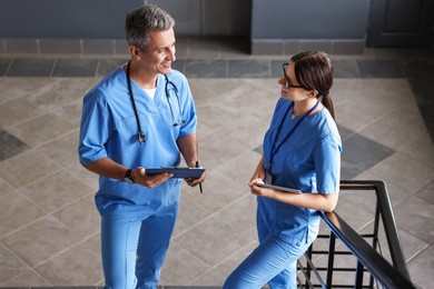 Healthcare workers talking on stairs in hospital