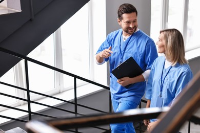 Photo of Healthcare workers talking on stairs in hospital