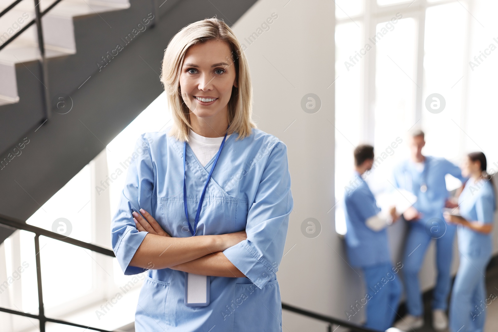 Photo of Smiling healthcare worker with badge in hospital