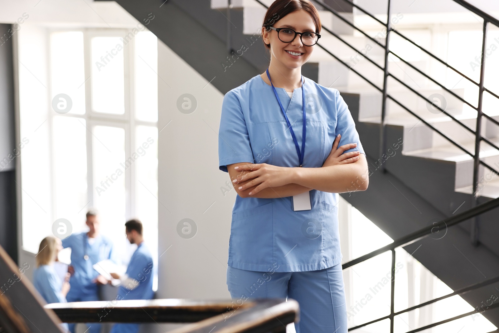 Photo of Smiling healthcare worker with badge in hospital