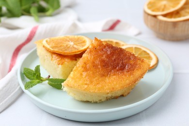 Photo of Tasty semolina cake served on white tiled table, closeup