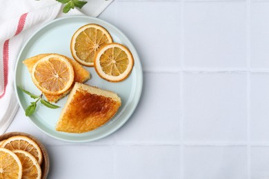 Tasty semolina cake served on white tiled table, flat lay. Space for text