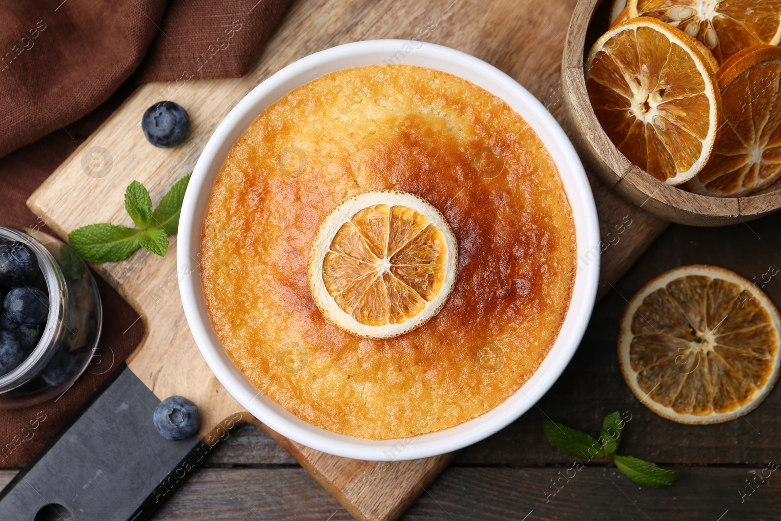 Photo of Tasty semolina cake served on wooden table, flat lay