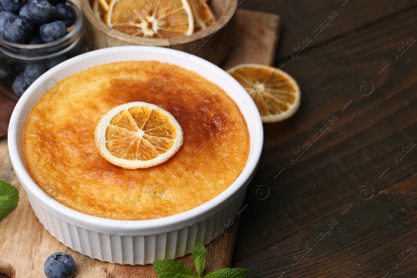 Photo of Tasty semolina cake served on wooden table, closeup. Space for text