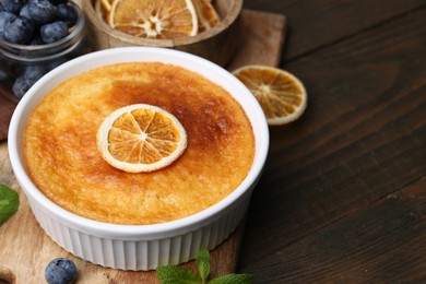 Photo of Tasty semolina cake served on wooden table, closeup. Space for text