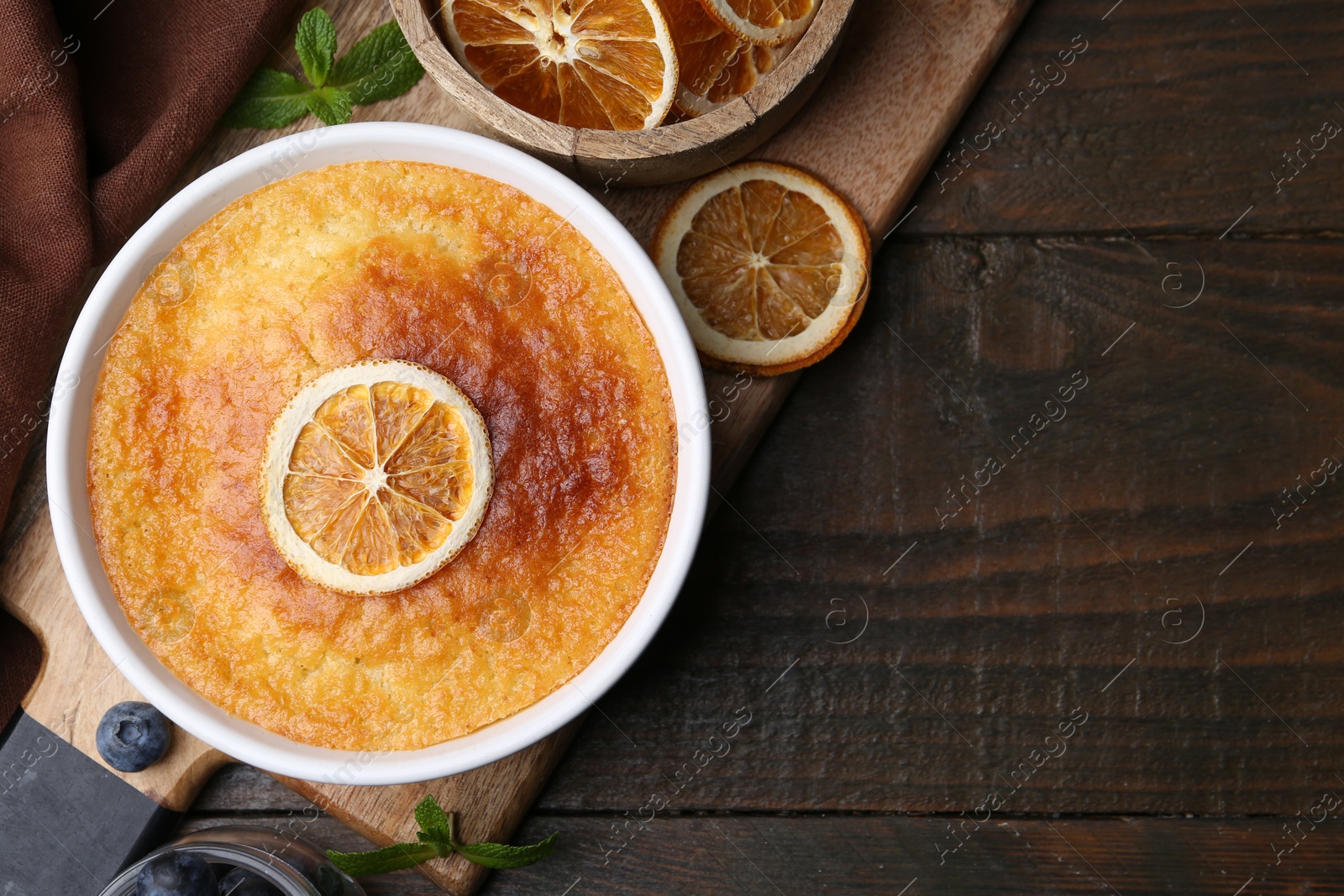 Photo of Tasty semolina cake served on wooden table, flat lay. Space for text