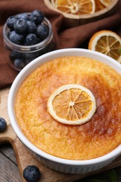 Photo of Tasty semolina cake served on wooden table, closeup