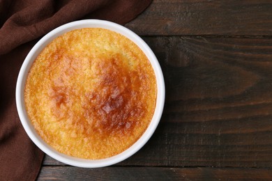 Photo of Tasty semolina cake served on wooden table, top view. Space for text