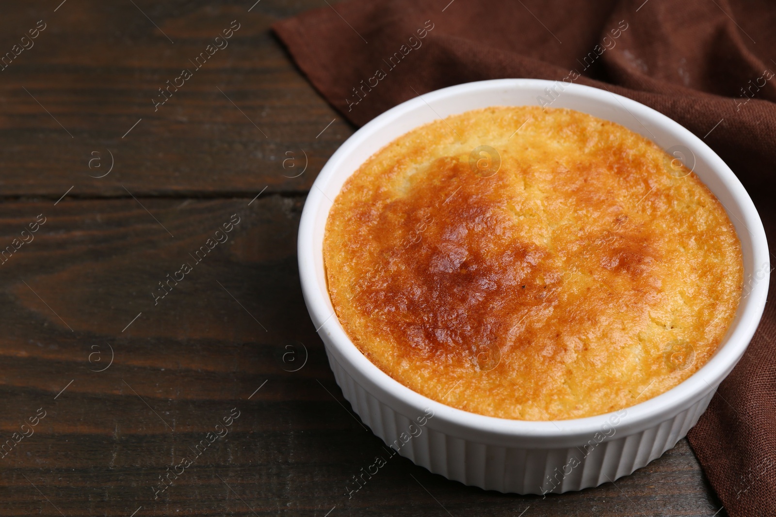 Photo of Tasty semolina cake served on wooden table, closeup. Space for text