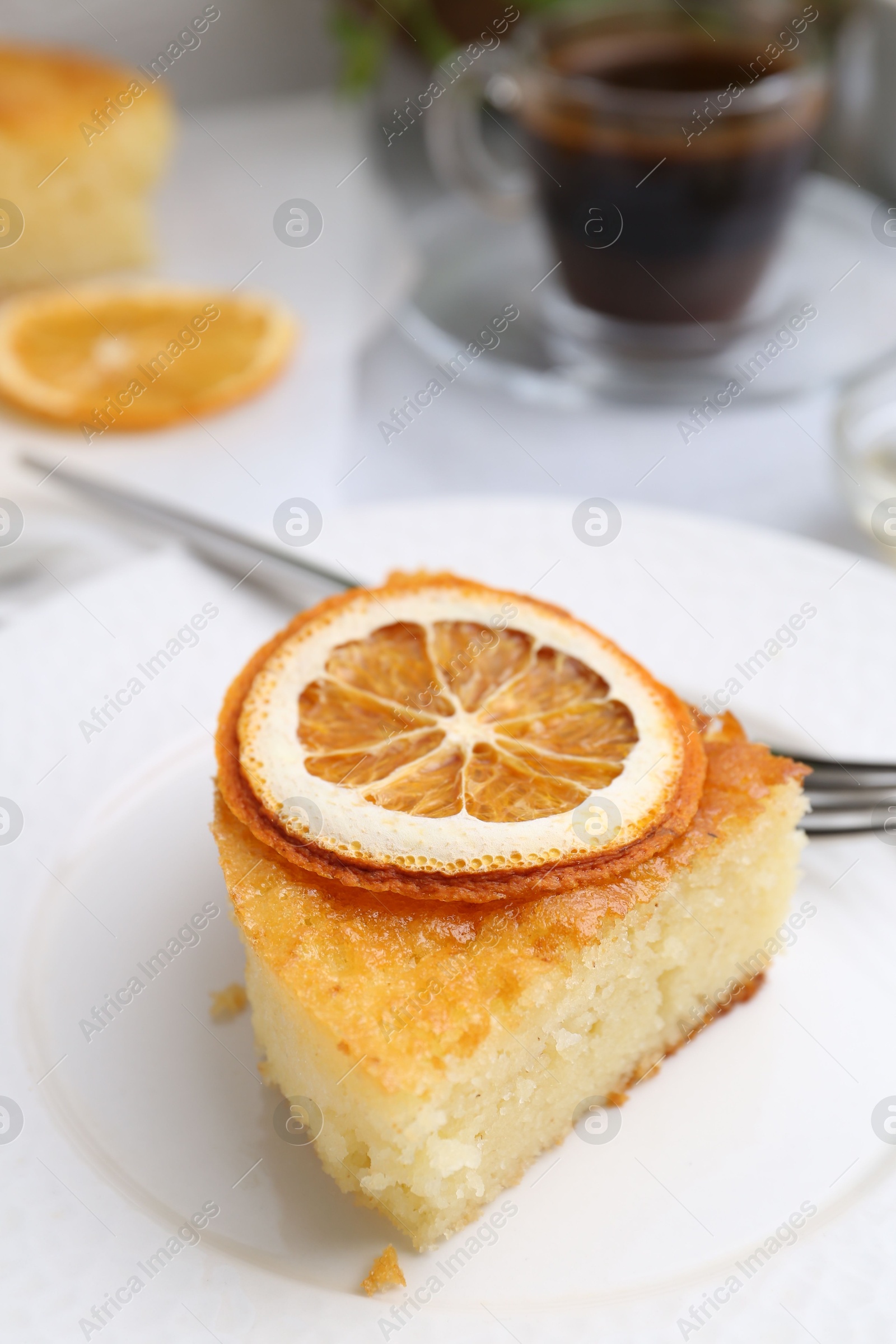 Photo of Slice of tasty semolina cake served on white table, closeup