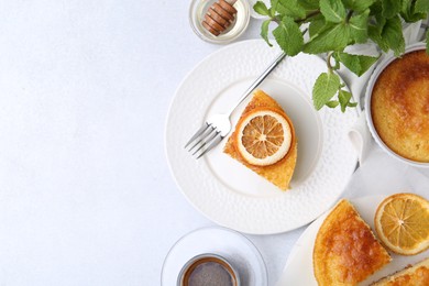 Photo of Slice of tasty semolina cake served on white table, flat lay. Space for text