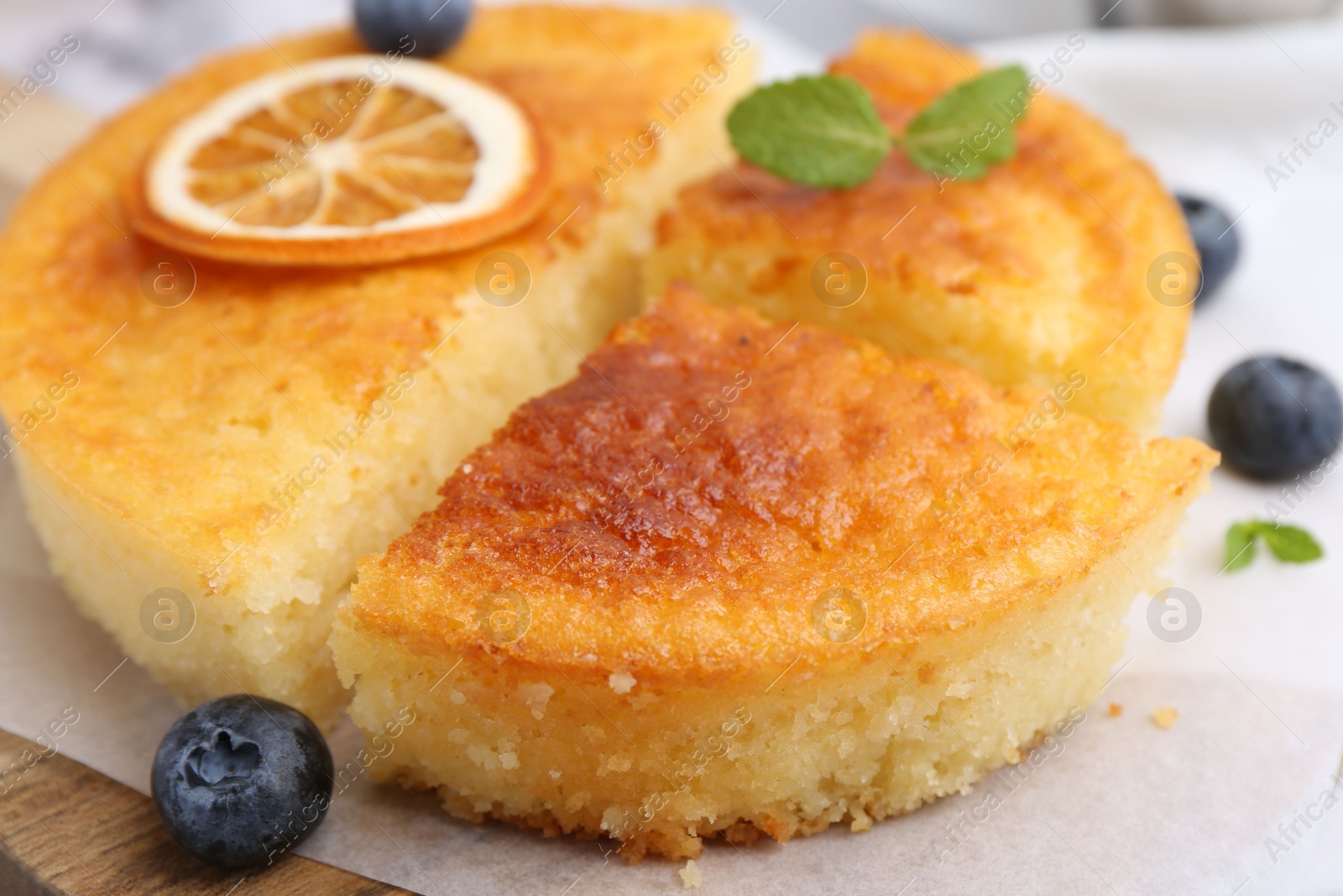 Photo of Tasty semolina cake served on white marble table, closeup