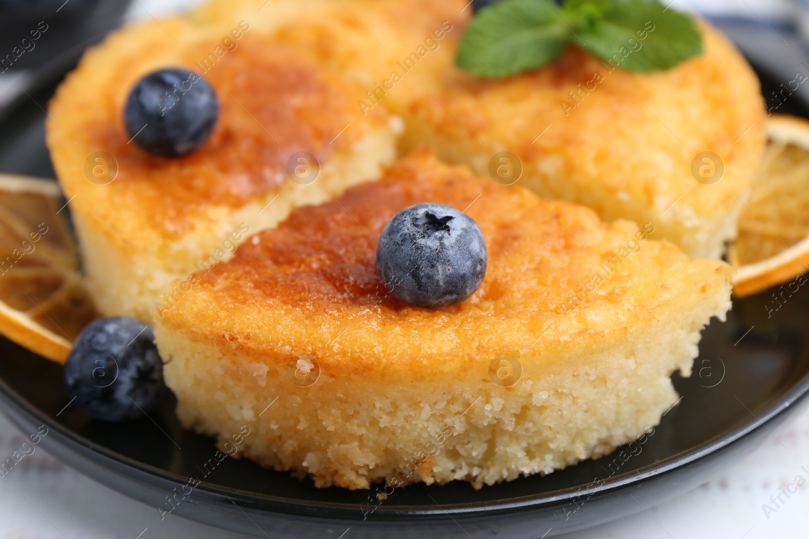 Photo of Delicious semolina cake with blueberries on white wooden table, closeup