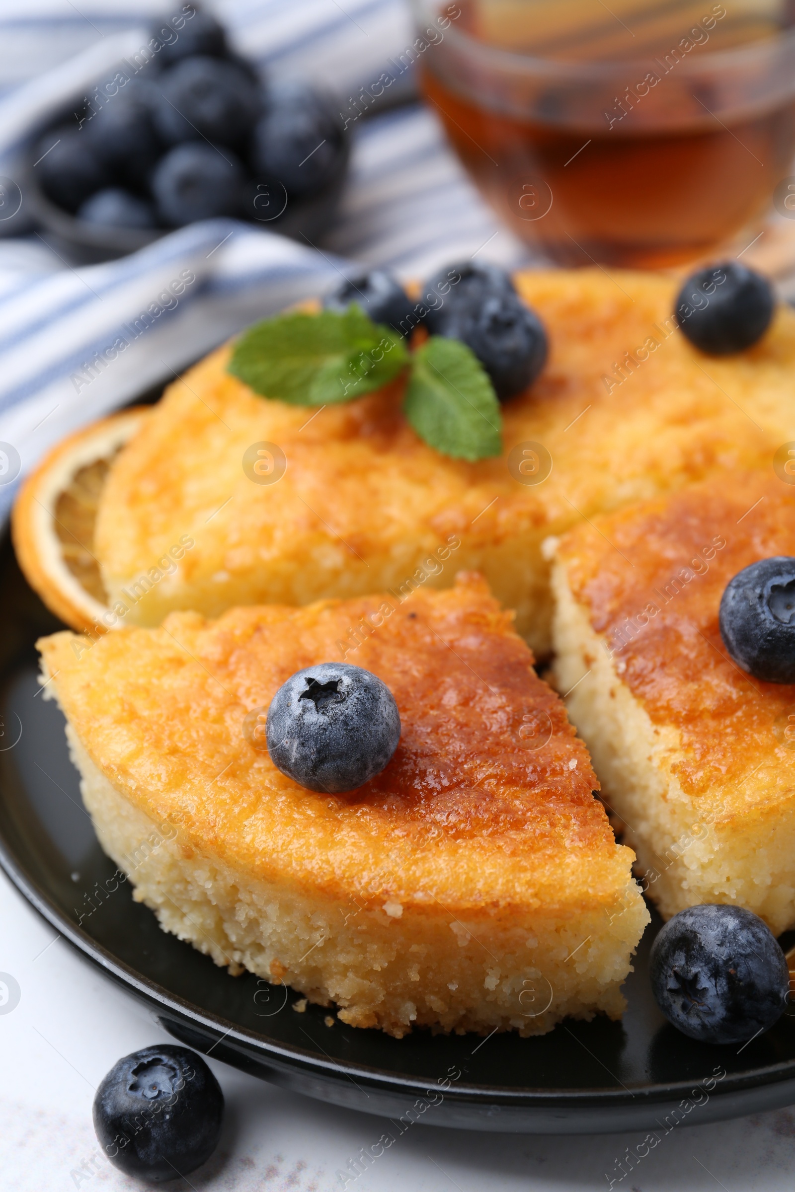 Photo of Delicious semolina cake with blueberries on white wooden table, closeup