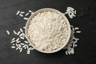 Photo of Puffed rice in bowl on dark table, top view