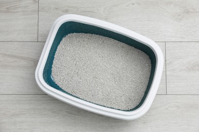 Photo of Cat tray with clumping litter on floor indoors, top view