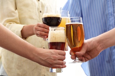 Photo of People with different types of beer clinking glasses, closeup