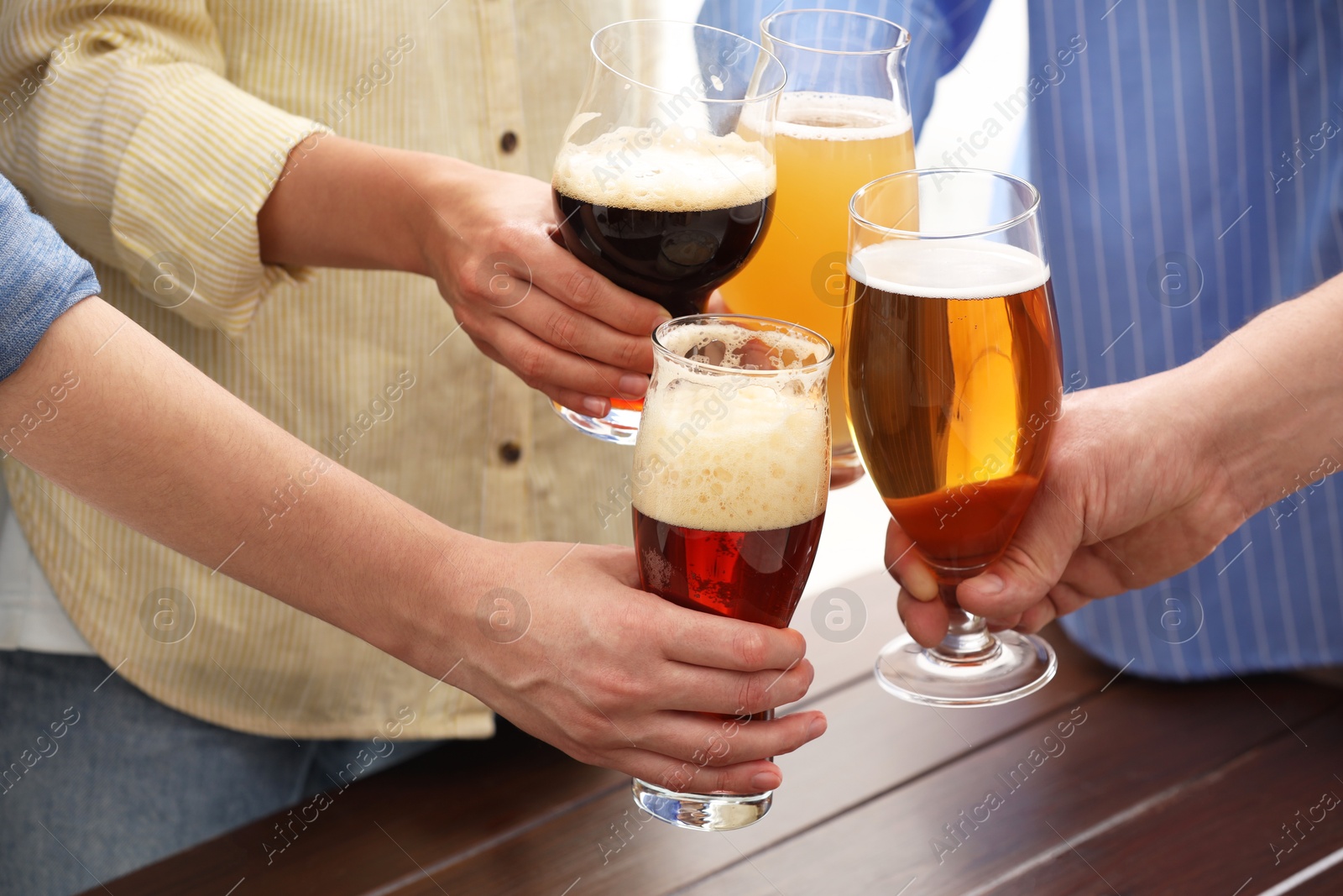 Photo of People with different types of beer clinking glasses, closeup