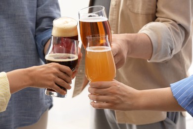 Photo of People with different types of beer clinking glasses, closeup