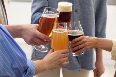 Photo of People with different types of beer clinking glasses, closeup