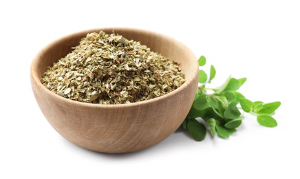 Photo of Dried oregano in bowl and green leaves isolated on white