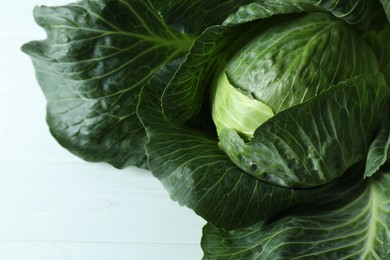 Photo of One ripe head of cabbage on white wooden table, top view