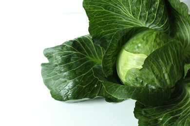 Photo of One ripe head of cabbage on white table, closeup